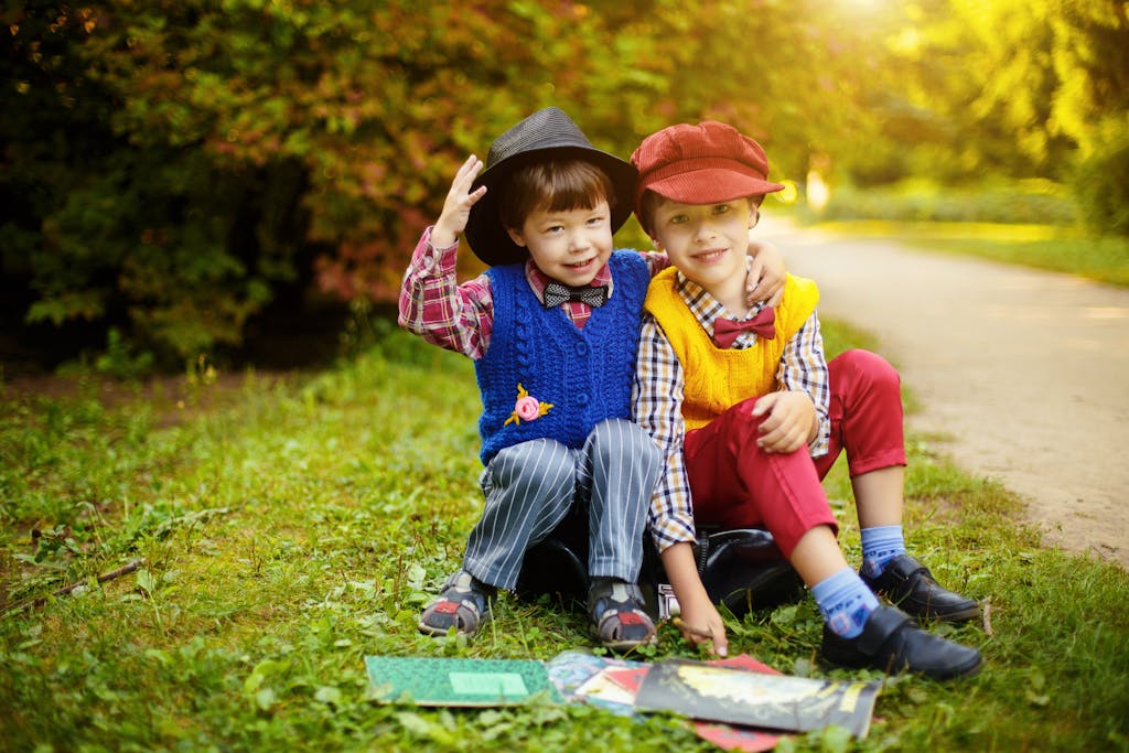 Boys Sitting On Grass